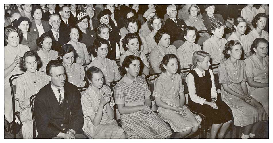 A portion of a photo of pupils and visitors