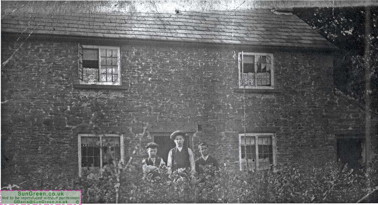 A photo of three people outside Rose Cottage