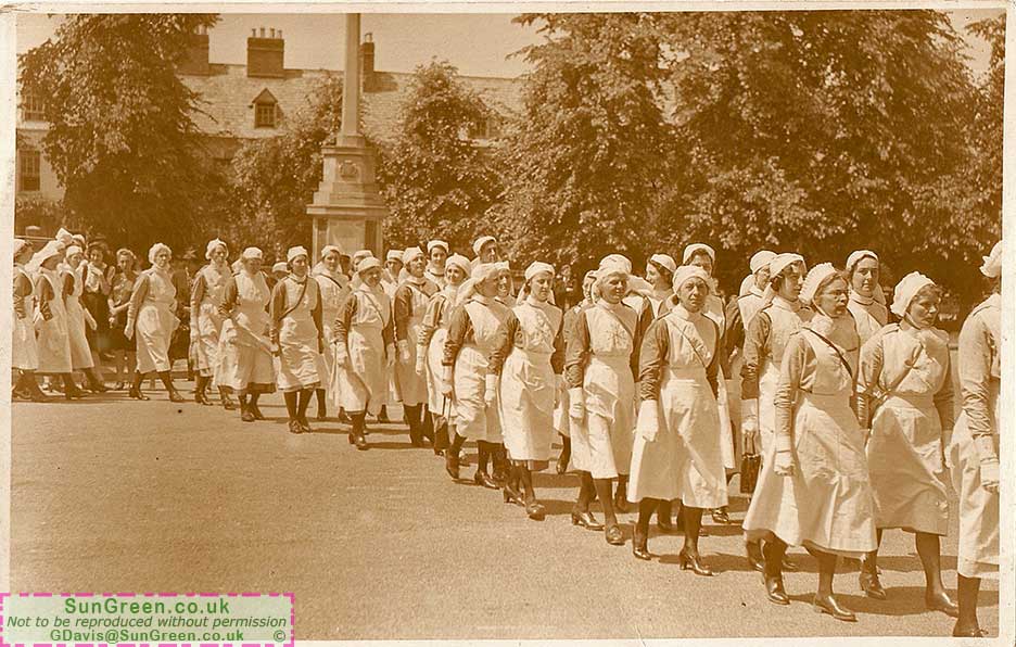 An old photo of nurses marching past Lydney Cenotaph