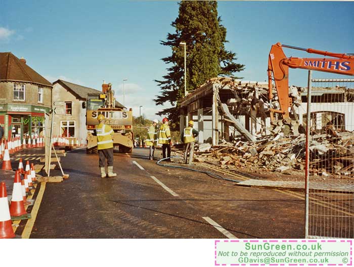 A photo of a machine demolishing Watts showroom, Lydney